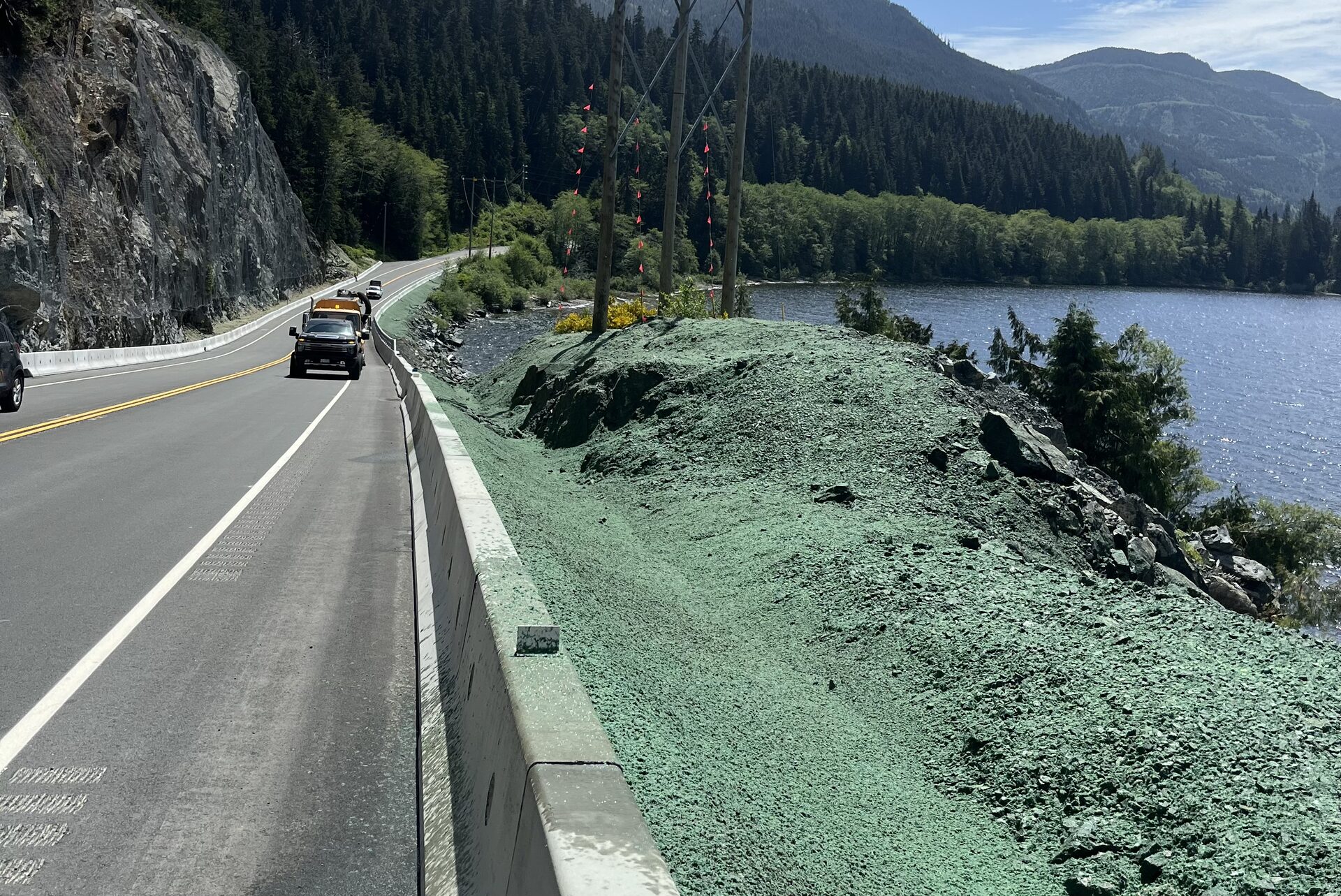 Freshly hydroseeded slope along a Vancouver Island highway overlooking the water